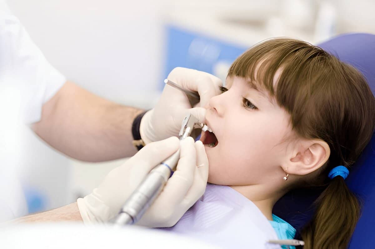 Child receiving pediatric dental cleaning in South Miami dental clinic